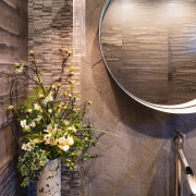 The powder room has a refined, textural presence. 