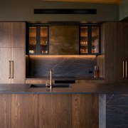 A patina brass rangehood cover, hand-folded around the 