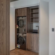 The laundry with in-keeping wood cabinetry is swept 