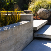 Shiplap concrete walls and planters help define areas. 