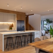 Overhead cabinetry and concealed storage ensure everyday essentials 