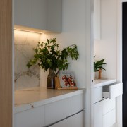 Side bench and cabinetry opening to the scullery 