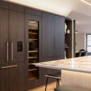 The island's overhanging slender benchtop is accentuated by 