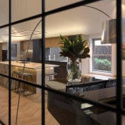 Looking through steel framed windows to the new 