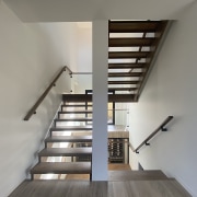 Stairs heading to basement level with wine cellar 