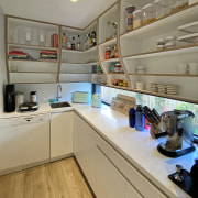 Scullery complete with curvaceous upper display cabinetry. 