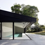 The pavilions' standing seam roofs contrast the farmhouse's 