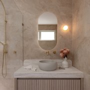 An oval mirror follows the soft lines of 