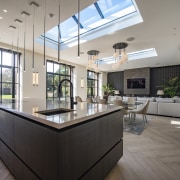 Thoughtful lighting choices, along with the skylights, add 