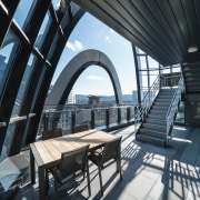 The office building's rounded, layered design results in architecture, building, daylighting, house, interior design, property, real estate, room, black