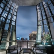 The 70m tall office building uses multiple strategies architecture, building, ceiling, city, commercial building, daylighting, design, furniture, glass, headquarters, interior design, landmark, lobby, metropolitan area, mixed-use, room, sky, symmetry, urban area, black, gray