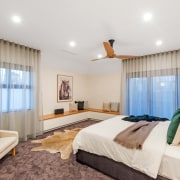 The first floor features a large main bedroom bed, bed frame, bed sheet, bedding, bedroom, boutique hotel, building, ceiling, comfort, curtain, floor, furniture, house, interior design, mattress, mattress pad, property, real estate, room, suite, textile, wall, window covering, window treatment, white