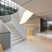 A wall of glass contributes to the staircase 