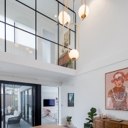 A pendant high over the dining table accentuates 