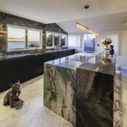 The granite’s textural patterning echoes moody brushstrokes in 