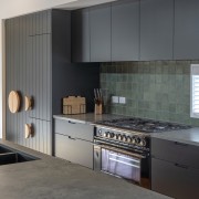 Kitchen cabinetry echoing aspects of the cladding. 