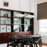 Dining area with display cabinetry behind, in the 