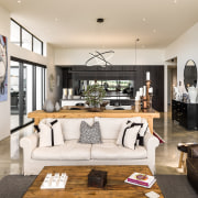 The double-height living area features, a raking ceiling 