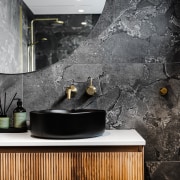 Stone-look tilework provides a complementary backdrop to the 