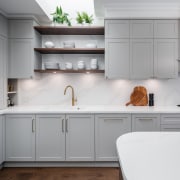 Cornices and panelled cabinetry give the kitchen a 