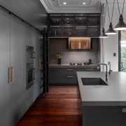 The sleek design features satin black cabinetry with 