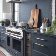 A large rangehood fully clad in blue soapstone 