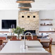 Flat screen tv sits alongside a rustic fireplace 