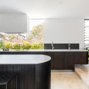 A giant window splashback floods the kitchen in 