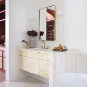 The refined vanity matches the floor finish while 
