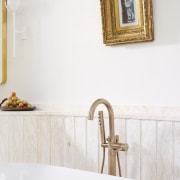 Gilded bath fixtures meet gilded painting frame. 