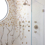 A glass screen and gilded fixtures remind you 