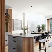 Vic Ash floors connect with the batten cabinetry 