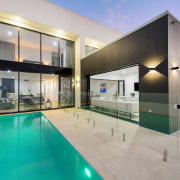 Glass balustrading optimises the home's stunning outlooks. The apartment, architecture, building, ceiling, design, estate, facade, glass, home, house, interior design, property, real estate, residential area, room, swimming pool, villa, gray