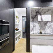 Marble surfaces give the kitchen an upmarket aesthetic. building, cabinetry, countertop, cupboard, floor, furniture, home appliance, house, interior design, kitchen, material property, property, room, wall, gray