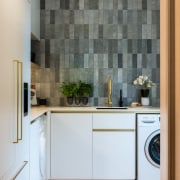 Brass tapware pings against the refined tile splashback 