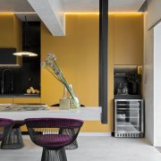 The mustard coloured cabinetry, set in contrast to architecture, building, cabinetry, ceiling, countertop, floor, furniture, home, house, interior design, kitchen, living room, material property, property, purple, real estate, room, table, violet, yellow