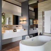 Travertine-look tiles on the floor of this renovated bathroom, interior design, room, gray, black