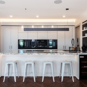 ​​​​​​​The kitchen is a gathering point in this cabinetry, countertop, cuisine classique, interior design, kitchen, white kitchen,  Gaggenau, Chancellor Construction, parquet floor, Arclinea kitchen, marble benchtop