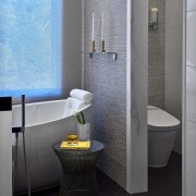 ​​​​​​​Textured wall tile meets marble door jamb on bathroom, bidet, ceramic, floor, interior design, plumbing fixture, room, tap, tile, toilet, toilet seat, gray, black