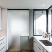 ​​​​​​​In this kitchen, a frosted glass door can architecture, countertop, house, interior design, kitchen, real estate, window, white, gray