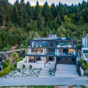 ​​​​​​​Instead of being built in schist and wood home, house, lakeside, Gary Todd Artchitecture. Glass,  concrete, 