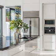 ​​​​​​​With a side door open, this kitchen is cabinetry, countertop, benchtop, Ceasarstone, classique, home appliance, kitchen, kitchen appliances, white Kitchen,  Emma Morris, Eternodesign