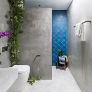 ​​​​​​​Vivid blue encaustic tiles add a splash of architecture, bathroom, interior design, gray, blue, tiles, grey, concrete vanity top