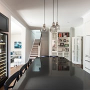 ​​​​​​​In this entertainer’s kitchen, the black pantry on interior design, white, black, kitchen, kitchen design, IL Kitchens, cabinetry, 