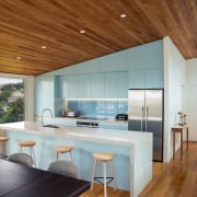 ​​​​​​​Finished in powder blue and defined by the architecture, ceiling, countertop, floor, house, interior design, table, wood, gray, brown, timber floor, Frans Kamermans