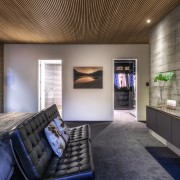 ​​​​​​​This home’s concrete tilt-slab construction continues into the architecture, interior design, bedroom, master suite, Kirsty Davis, timber batten ceiling