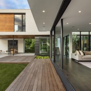 ​​​​​​​A series of glass sliding panels allows the architecture, deck, home, house, interior design, living room, patio, window, sliding windows, Peterssen Keller Architects