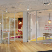 Two four-person meeting rooms sit just inside the ceiling, door, floor, flooring, glass, interior design, gray