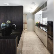 ​​​​​​​This galley kitchen offers ample storage and is architecture, kitchen, cabinetry, countertop, benchtop, flooring, home, house, interior design, kitchen, , tile, gray, black, galley kitchen, Archer Design