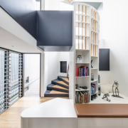 ​​​​​​​The spiral staircase in this family home by home, house, bookcase, design, floor, flooring, furniture, home, house, interior design, living room, shelf, shelving, space, stairs, CplusC Architectural Workshop
